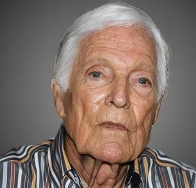 Richard Chamberlain malujący obraz, z pędzlem w dłoni, zamyślony nad płótnem, w tle subtelne nawiązanie do Hawajów.
