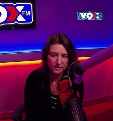 Renata Dąbkowska, polska piosenkarka, w trakcie dynamicznego występu na scenie, trzymająca mikrofon.